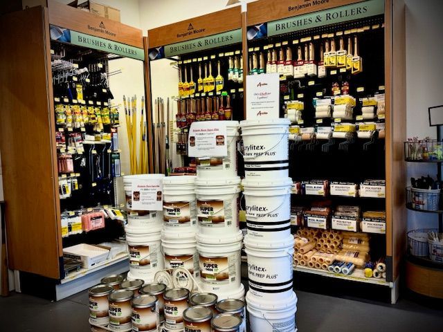 Buckets of paint are stacked on top of each other in a store