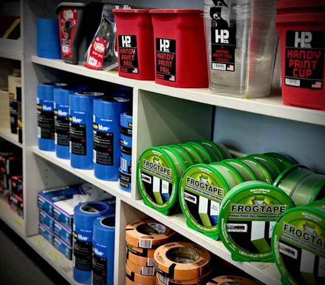 A shelf full of frogtape and buckets of hp handy putty