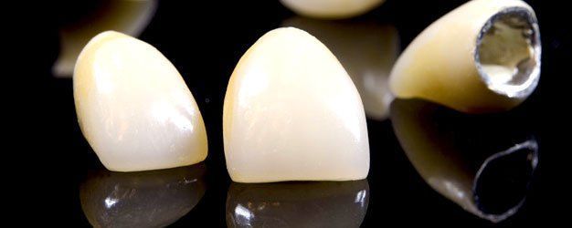 Two cream-colored teeth on black background, with one tooth shown in cross-section exposing a hollow cavity