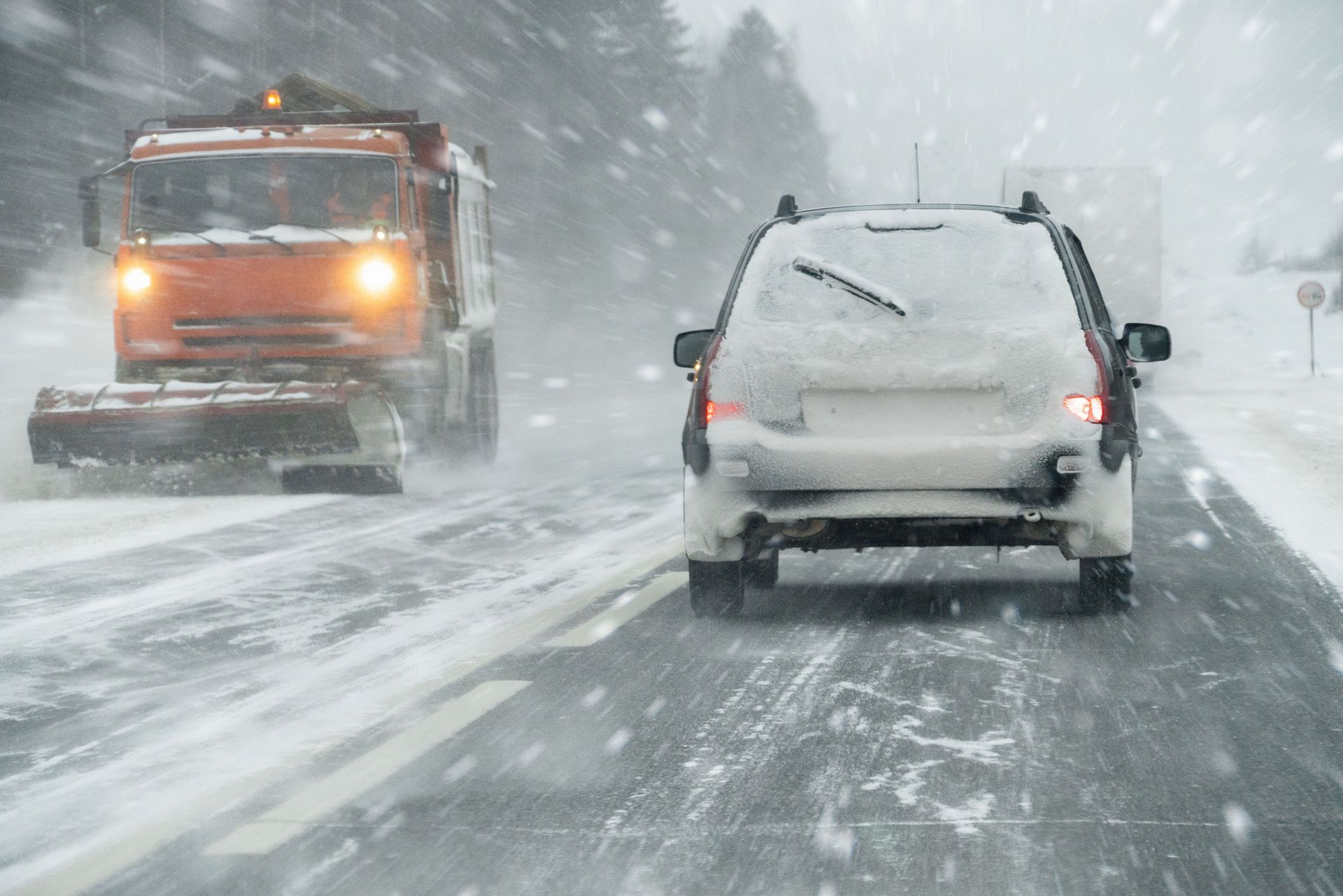 Free Winter Car Check from Ultimate Automotive Service Center with snow-covered tire in Urbandale.