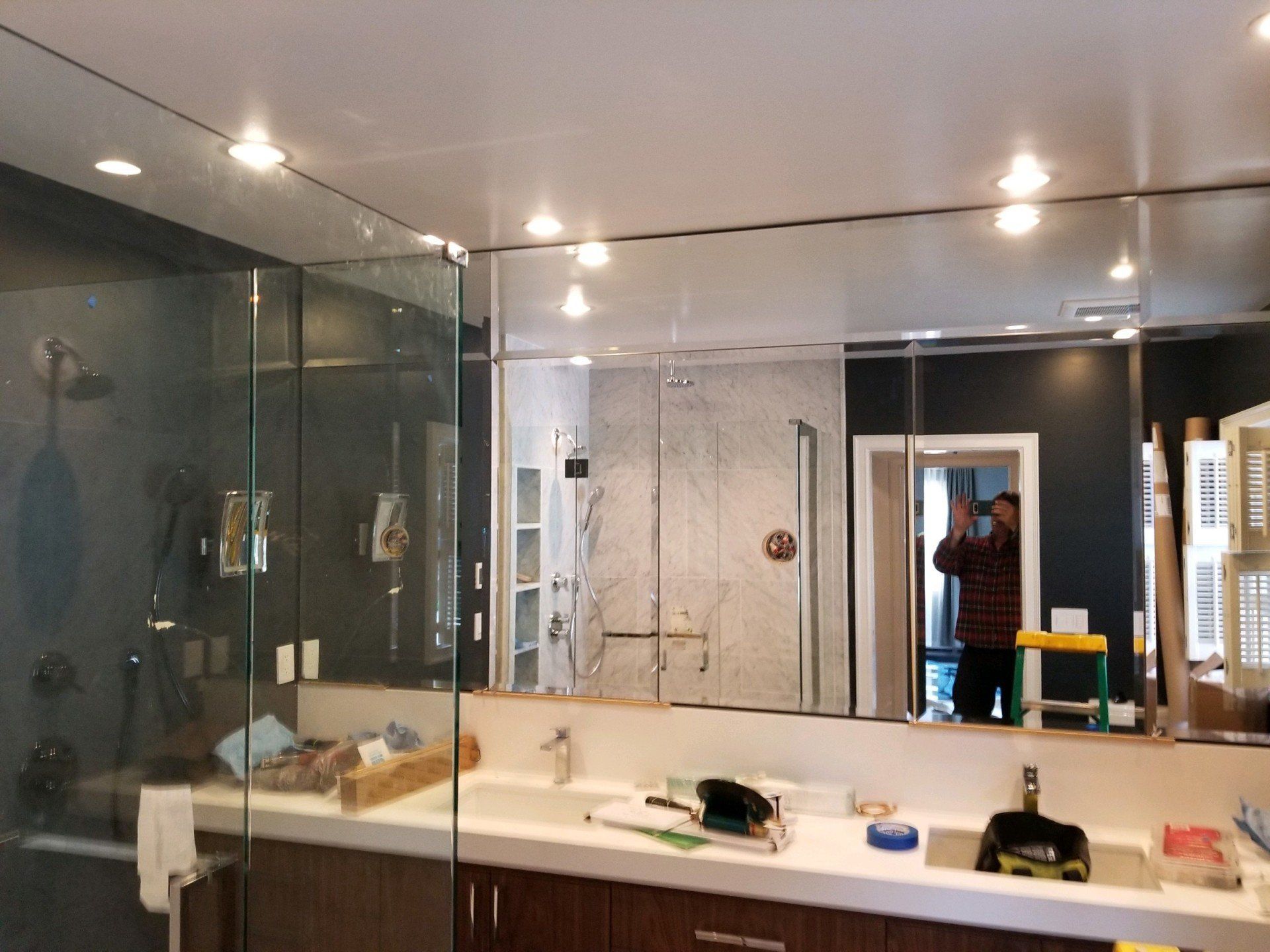 A bathroom with two sinks and a large mirror