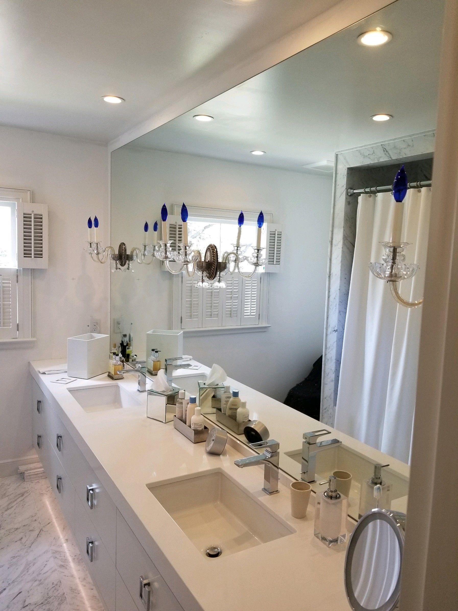 A bathroom with two sinks and a large mirror