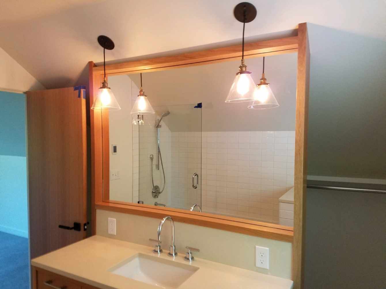 A bathroom with a sink and a large mirror