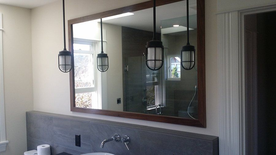 A bathroom with a large mirror and a sink