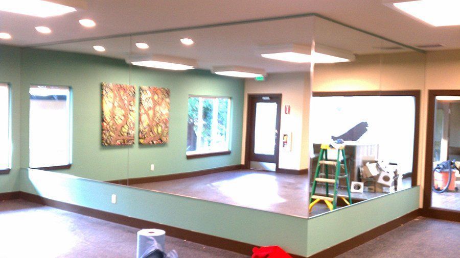 An empty room with a large mirror on the wall.