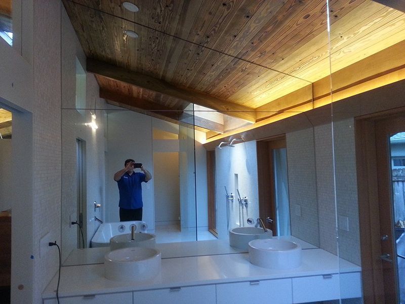 A man taking a picture of himself in a bathroom mirror