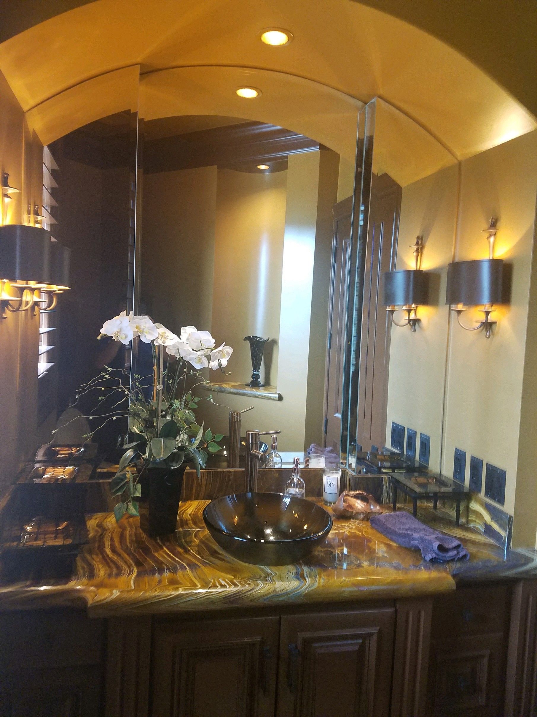 A bathroom with a sink and a large mirror