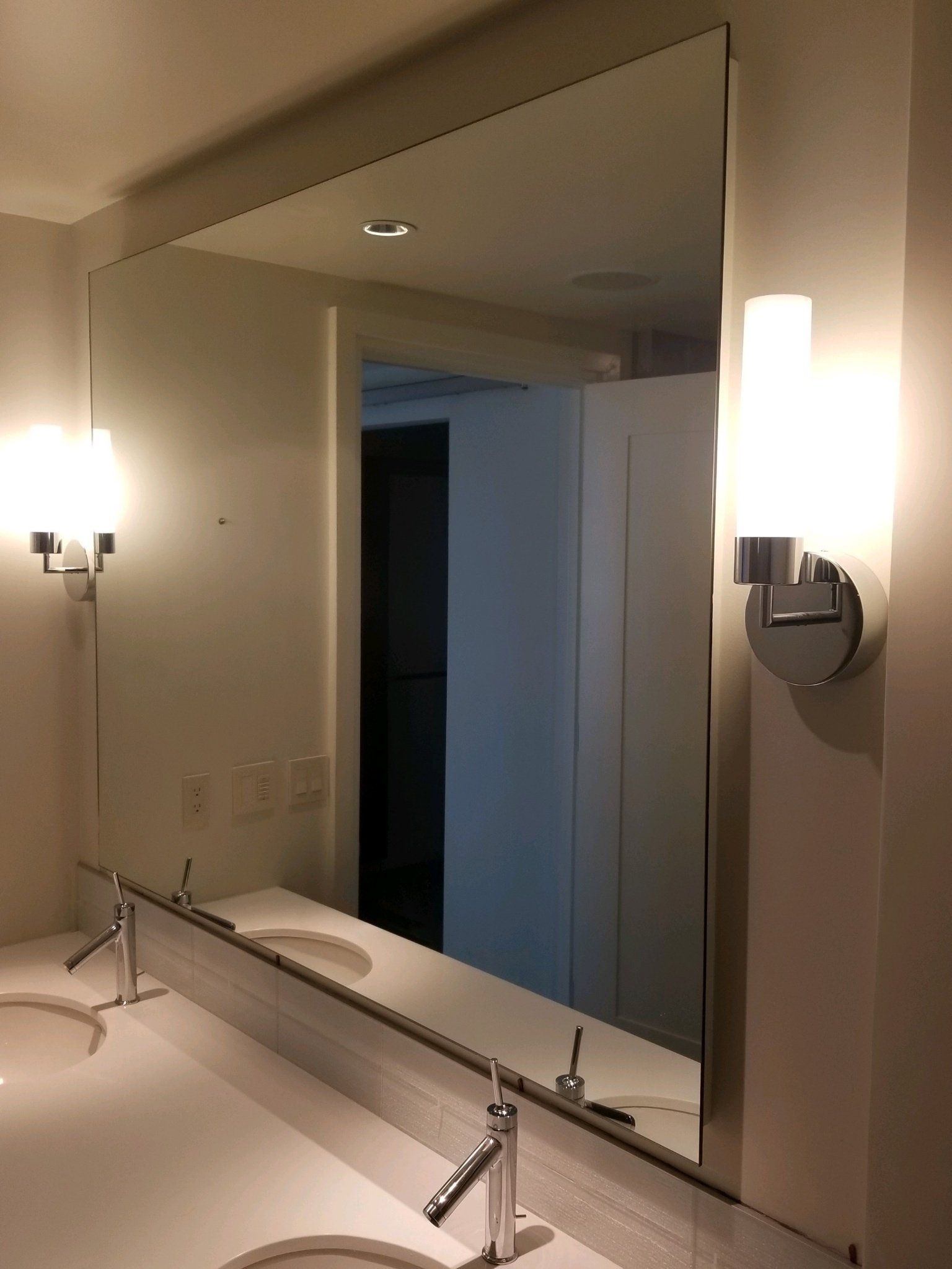 A bathroom with two sinks and a large mirror
