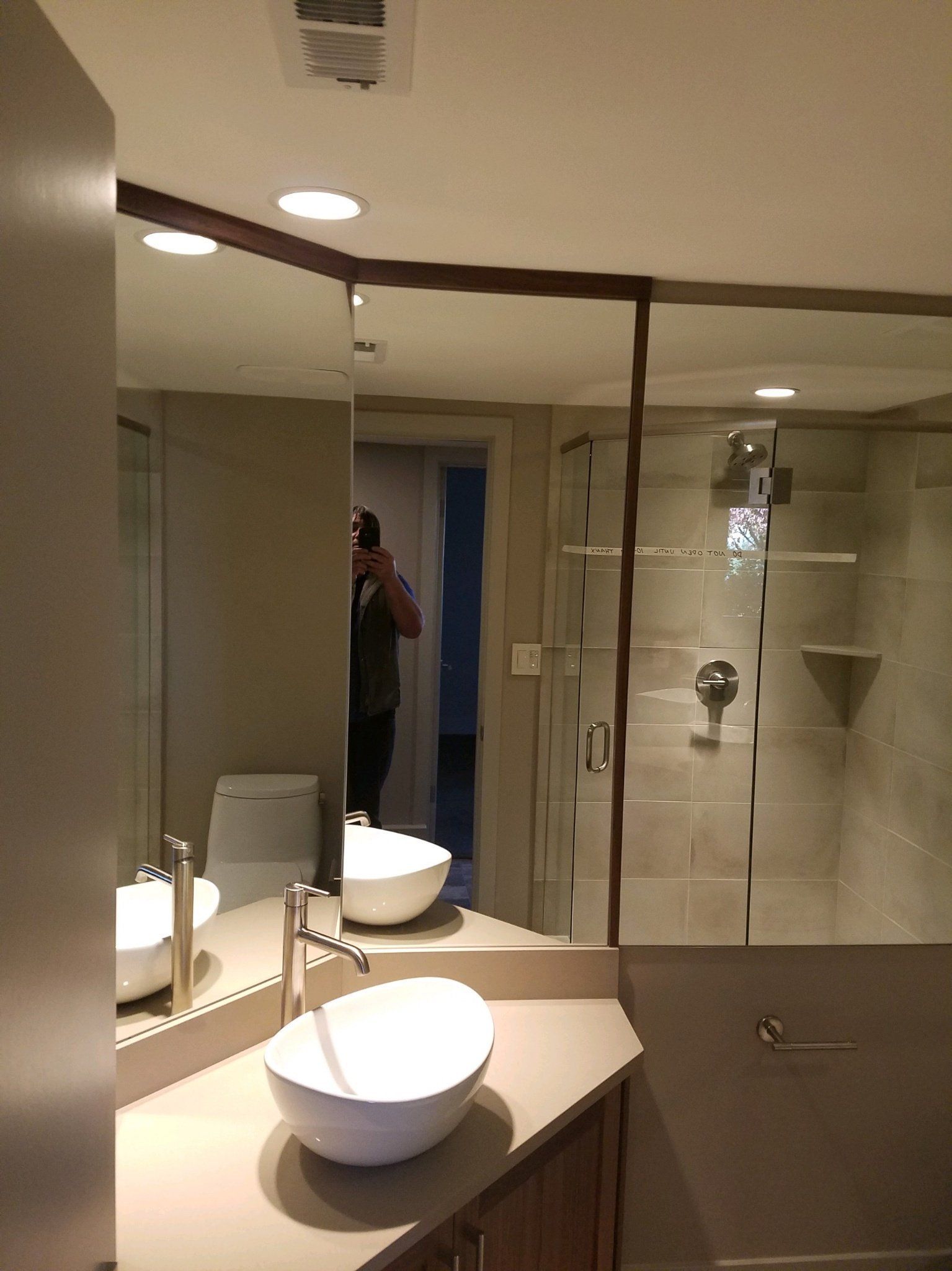 A bathroom with two sinks and a large mirror