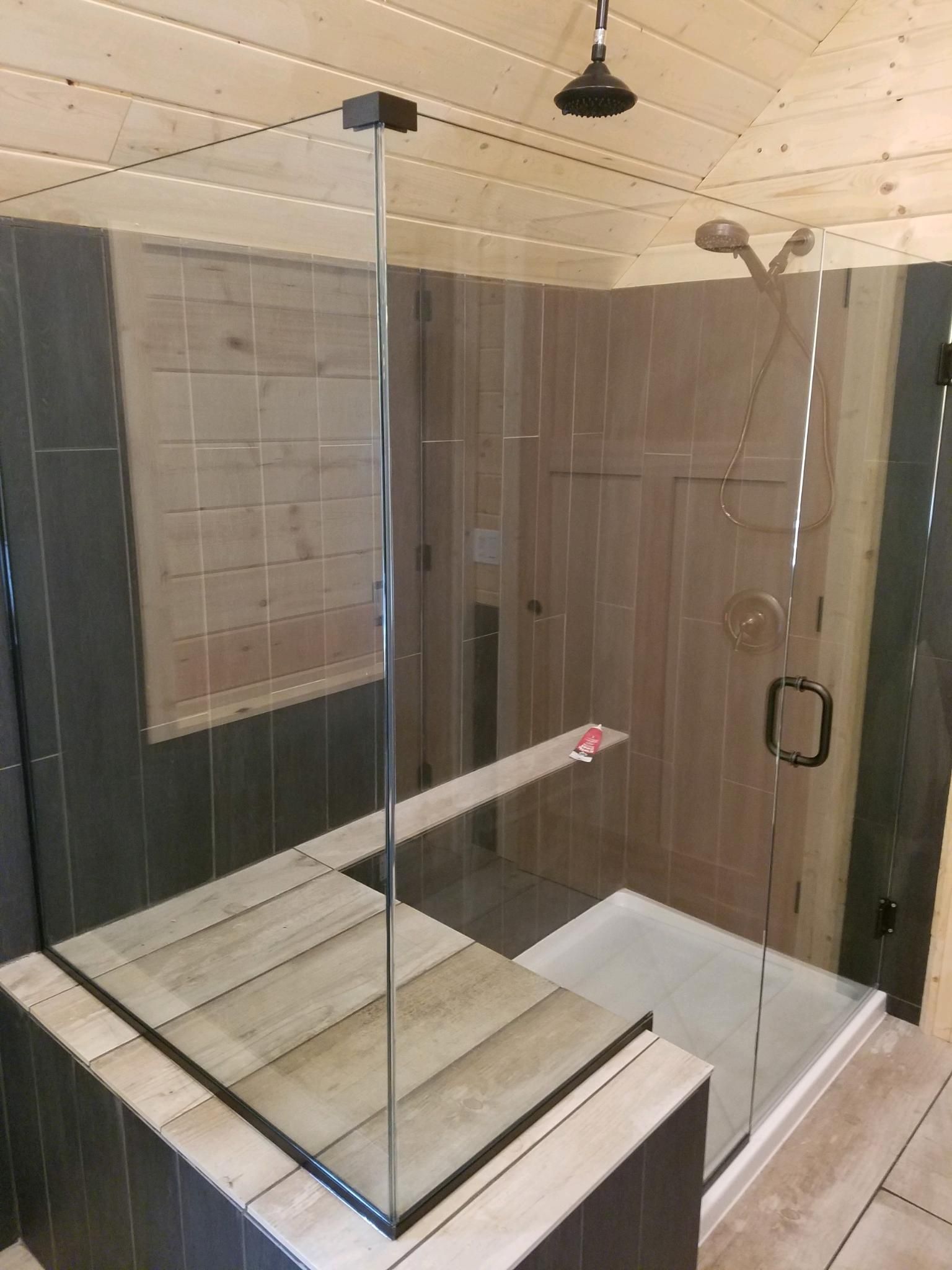 A bathroom with a walk in shower and a bathtub.