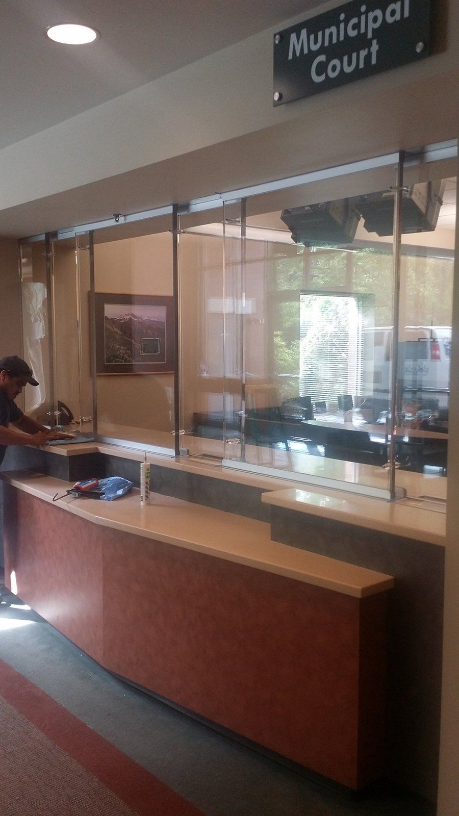 A man is working at a counter in a municipal court building.