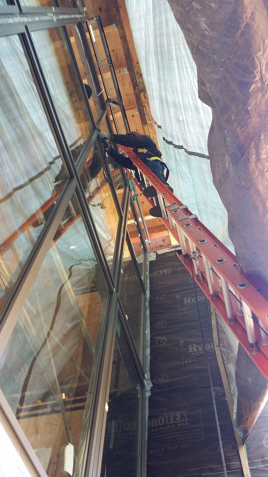 A person is using a ladder to climb up a set of stairs.