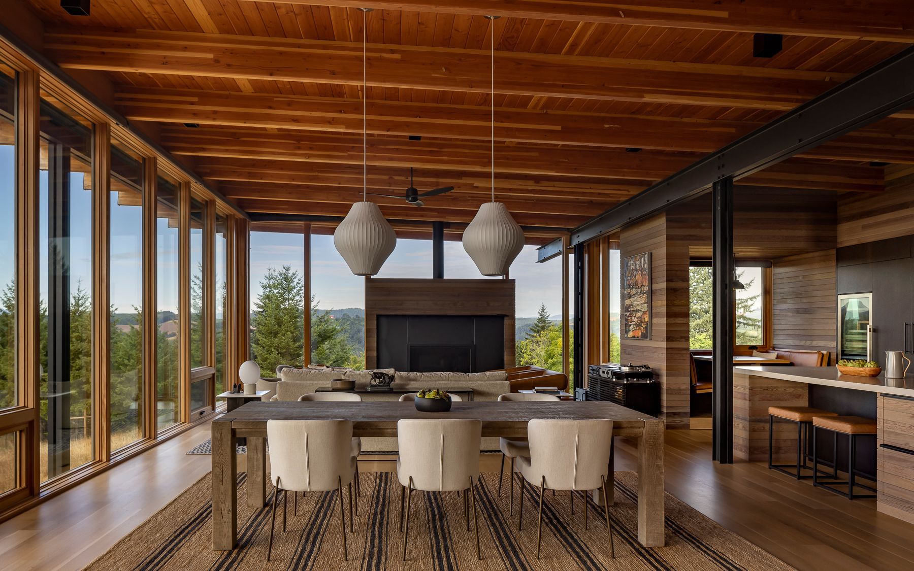 A dining room in a house with a large table and chairs.