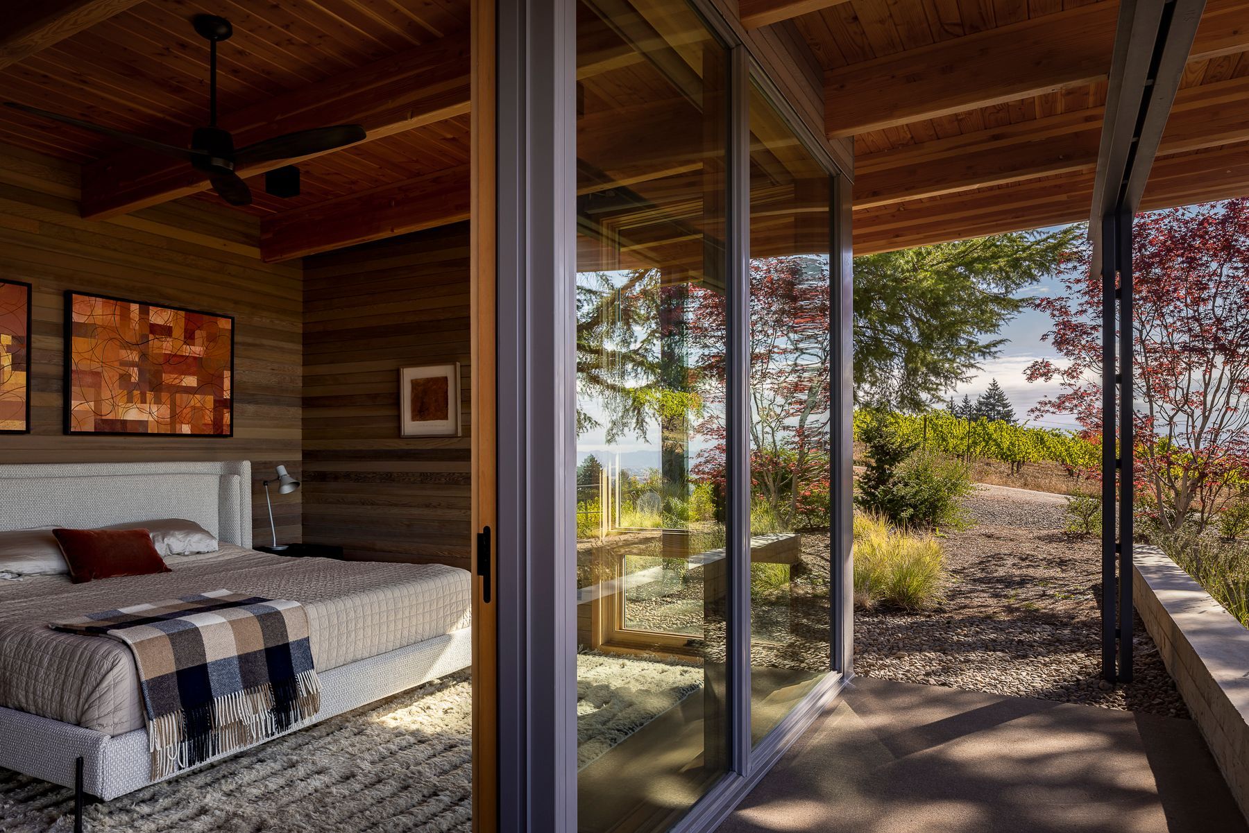 A bedroom with a large bed and lots of windows.