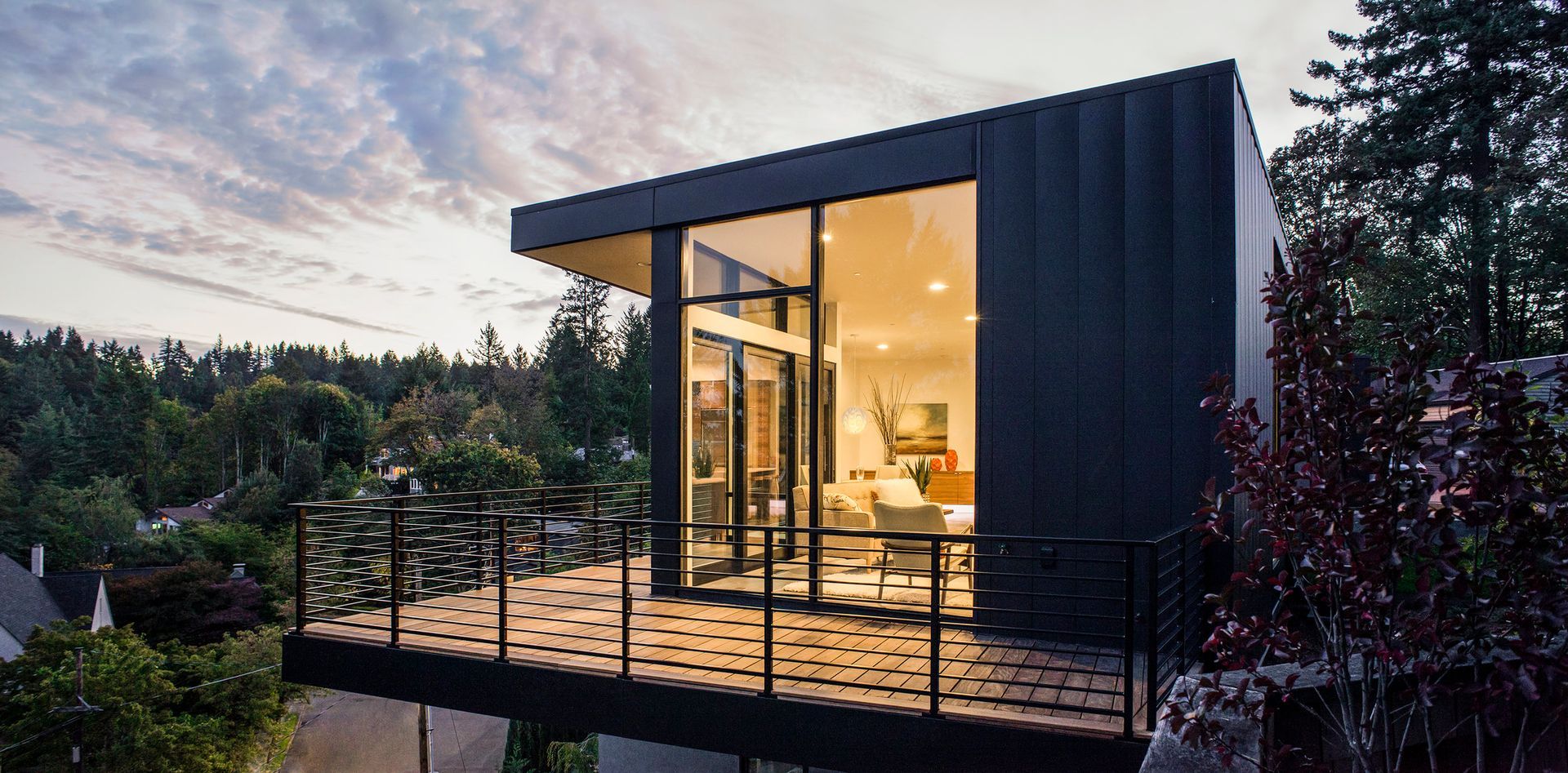 A modern house with a balcony and a lot of windows.