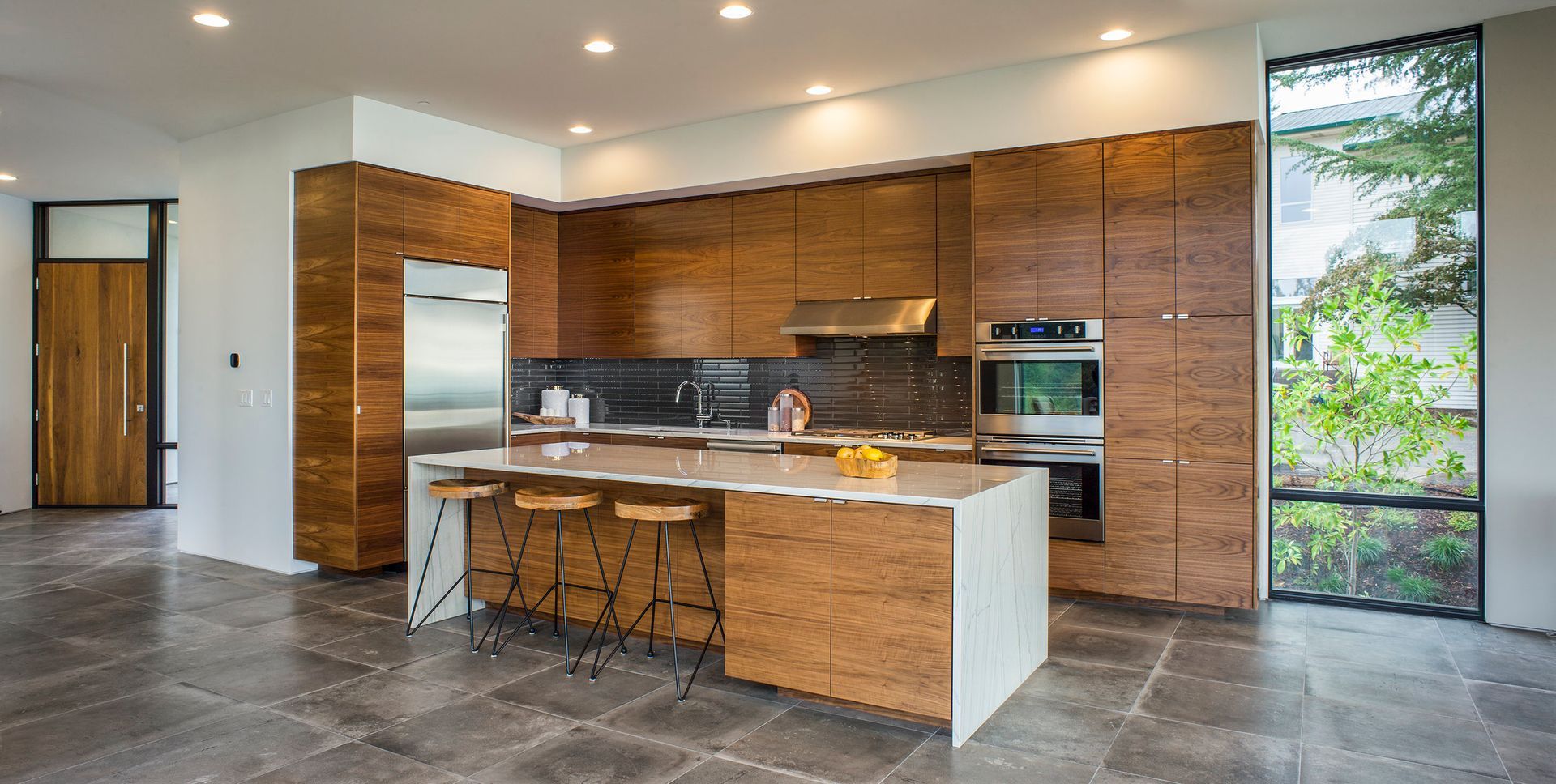A modern kitchen with wooden cabinets and stainless steel appliances.