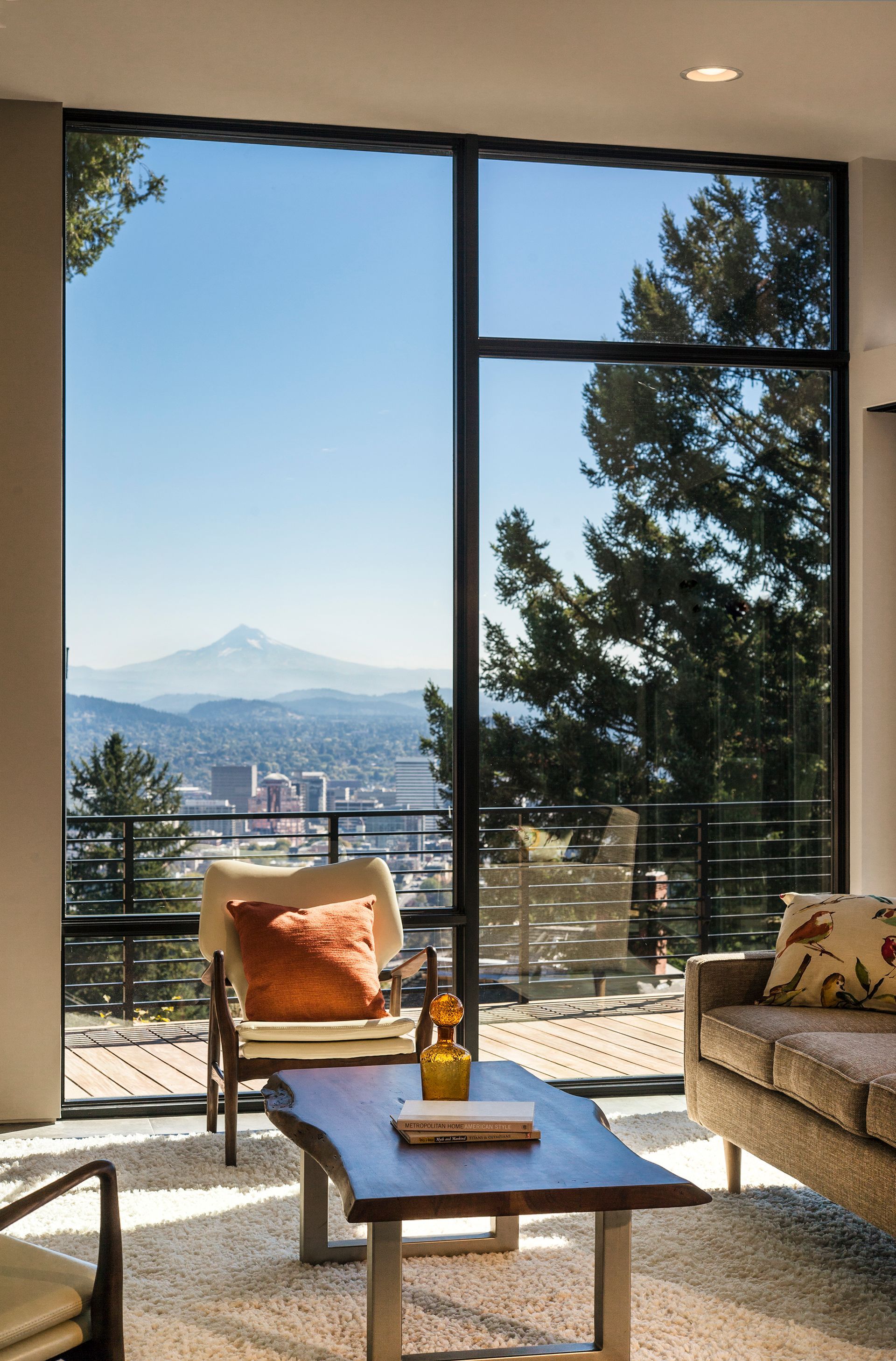 A living room with a view of a city and mountains