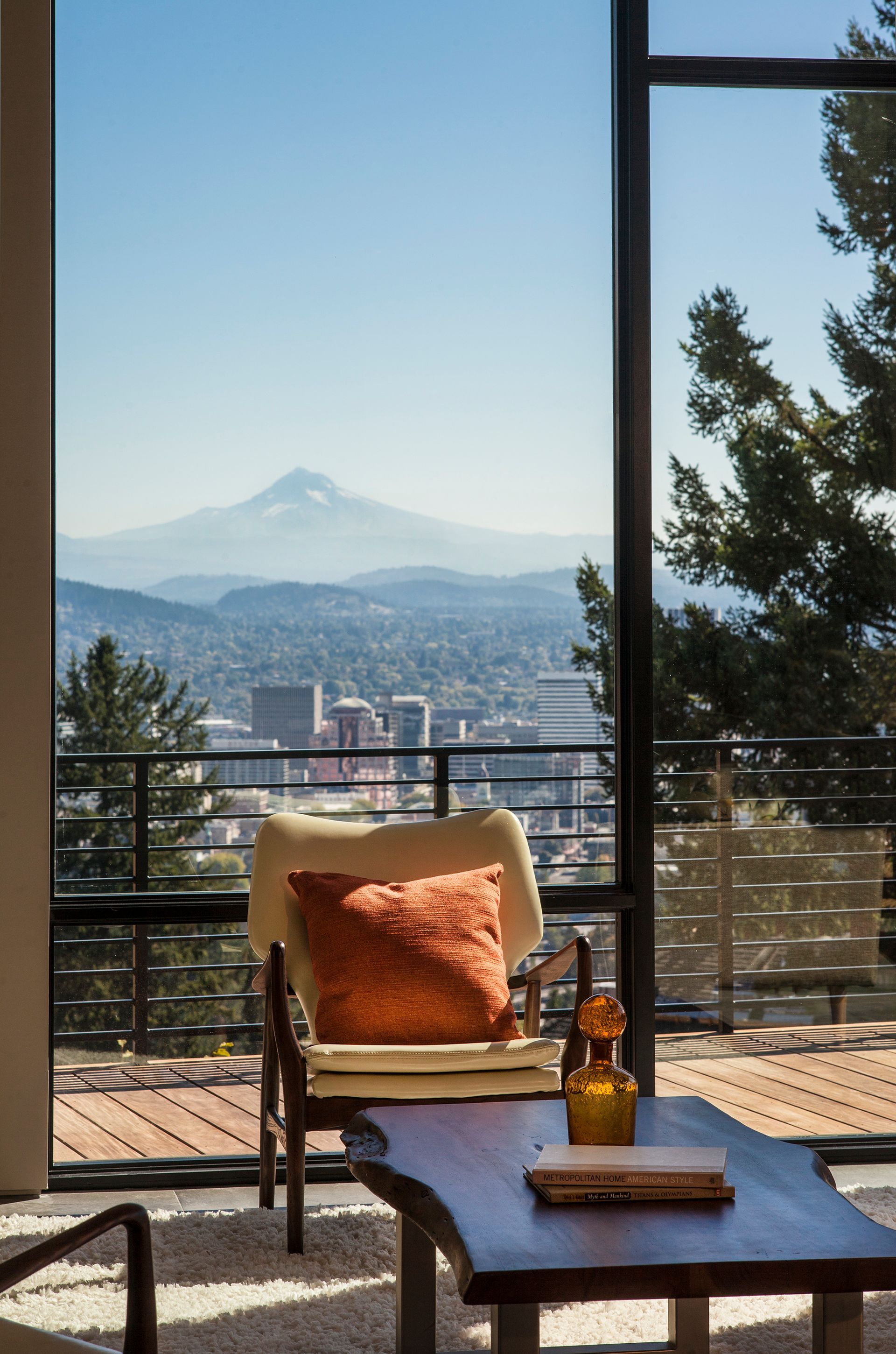A living room with a view of a city and mountains