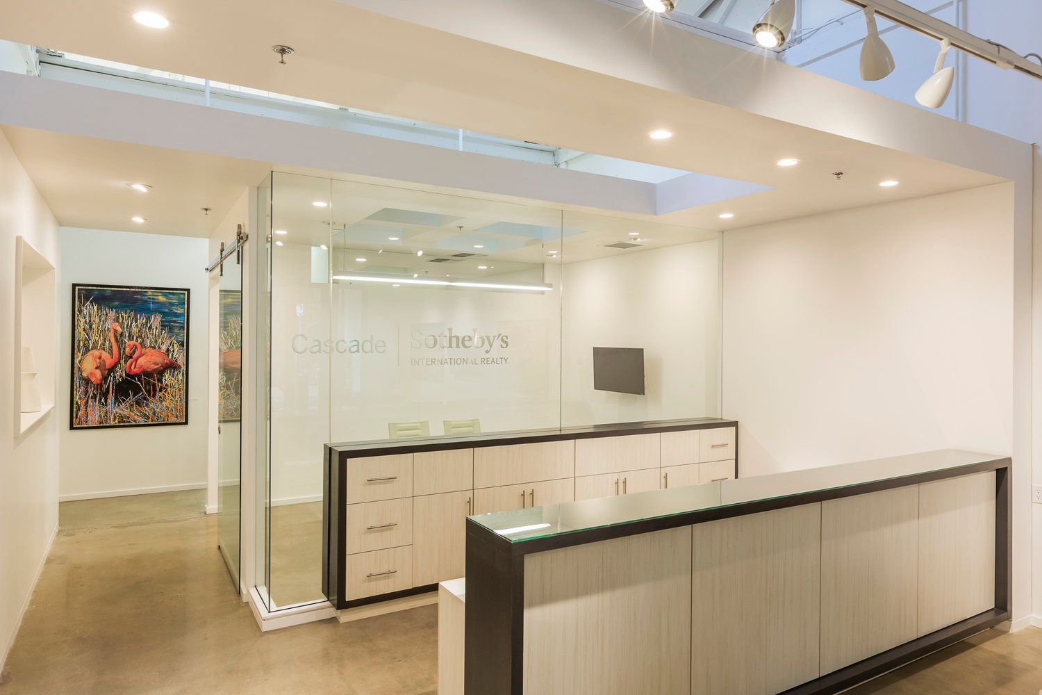 A reception area with a glass wall and a long counter.