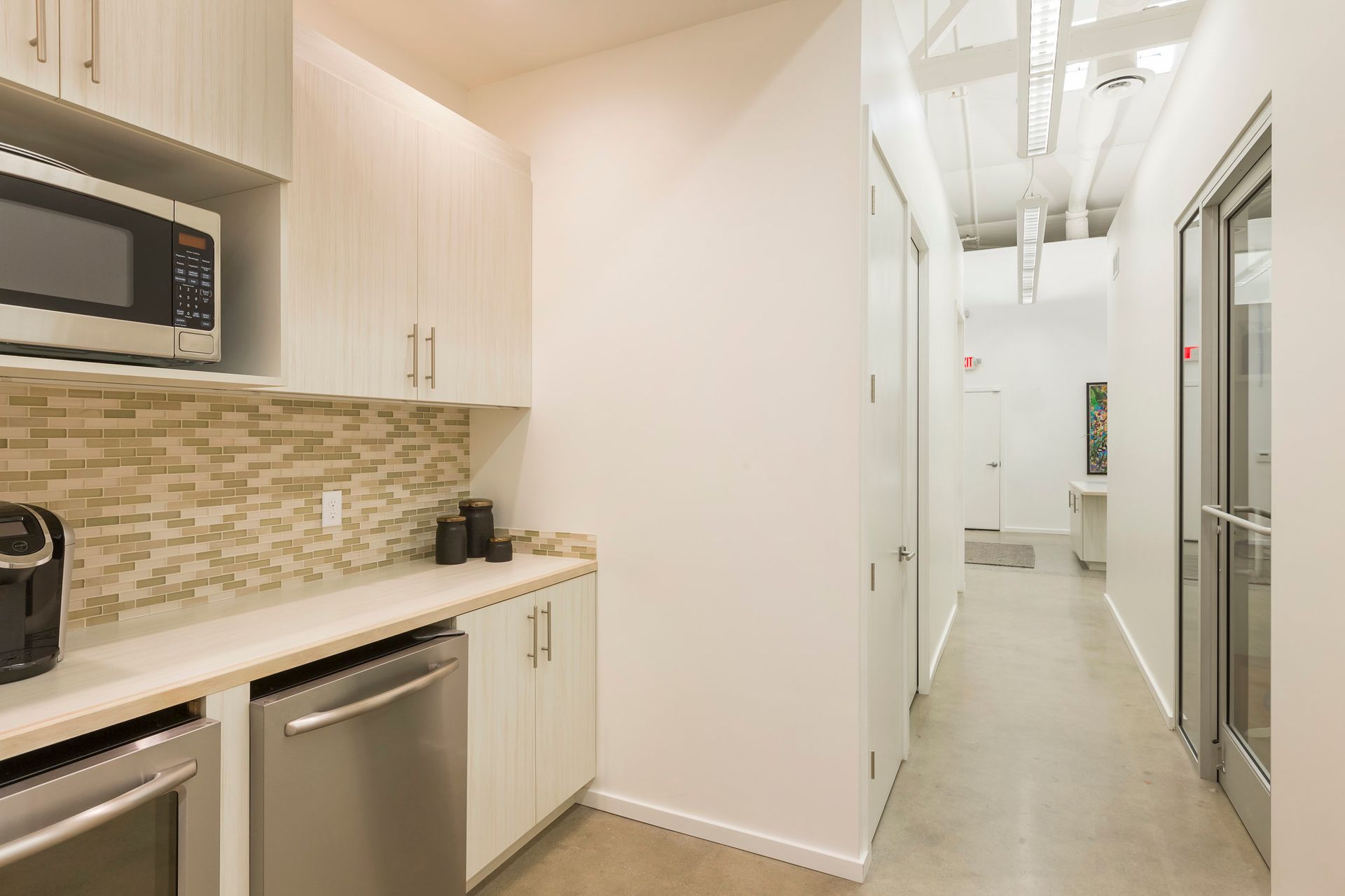 A kitchen with stainless steel appliances and a microwave