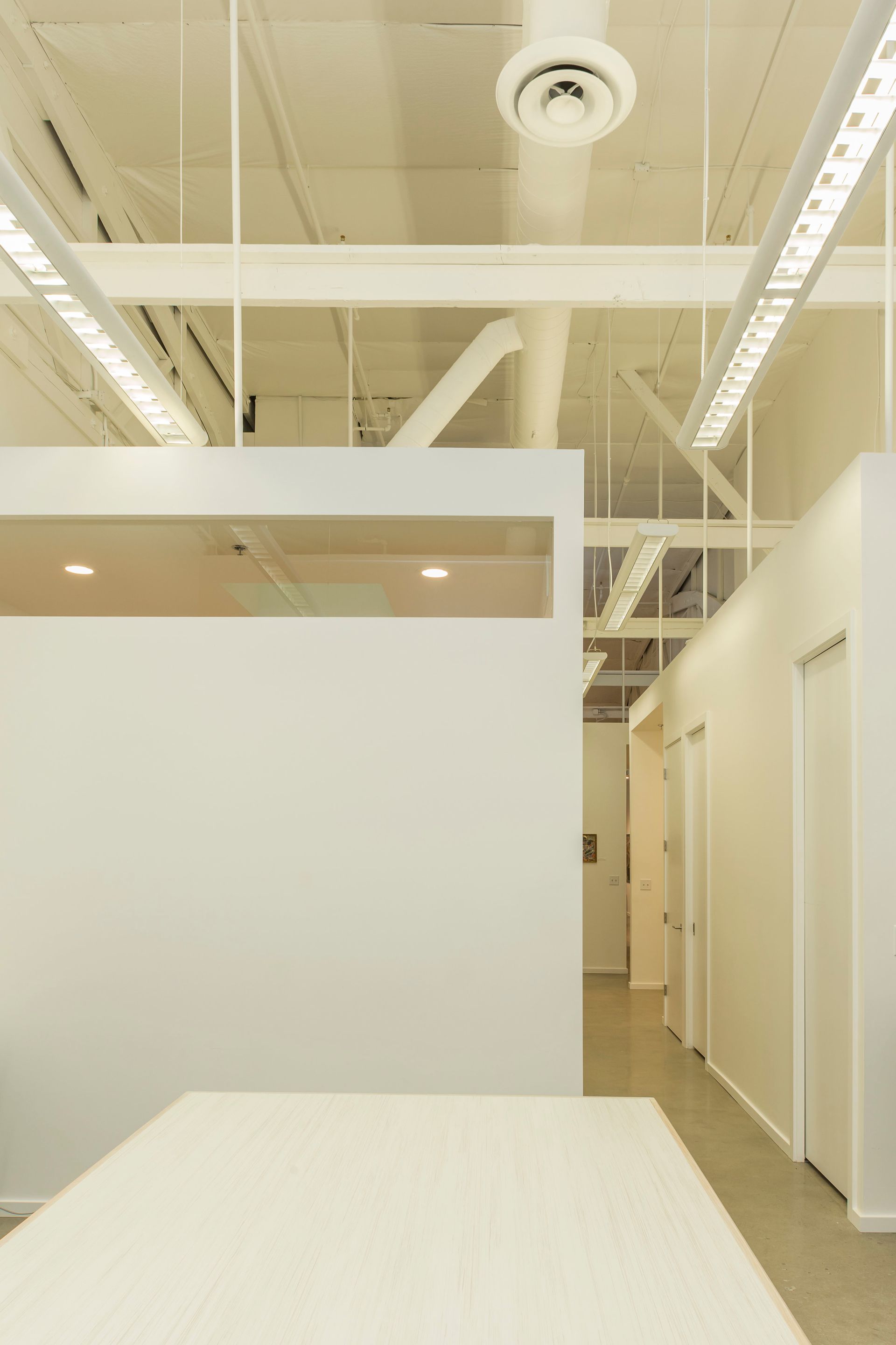 There is a large white table in the middle of the room.