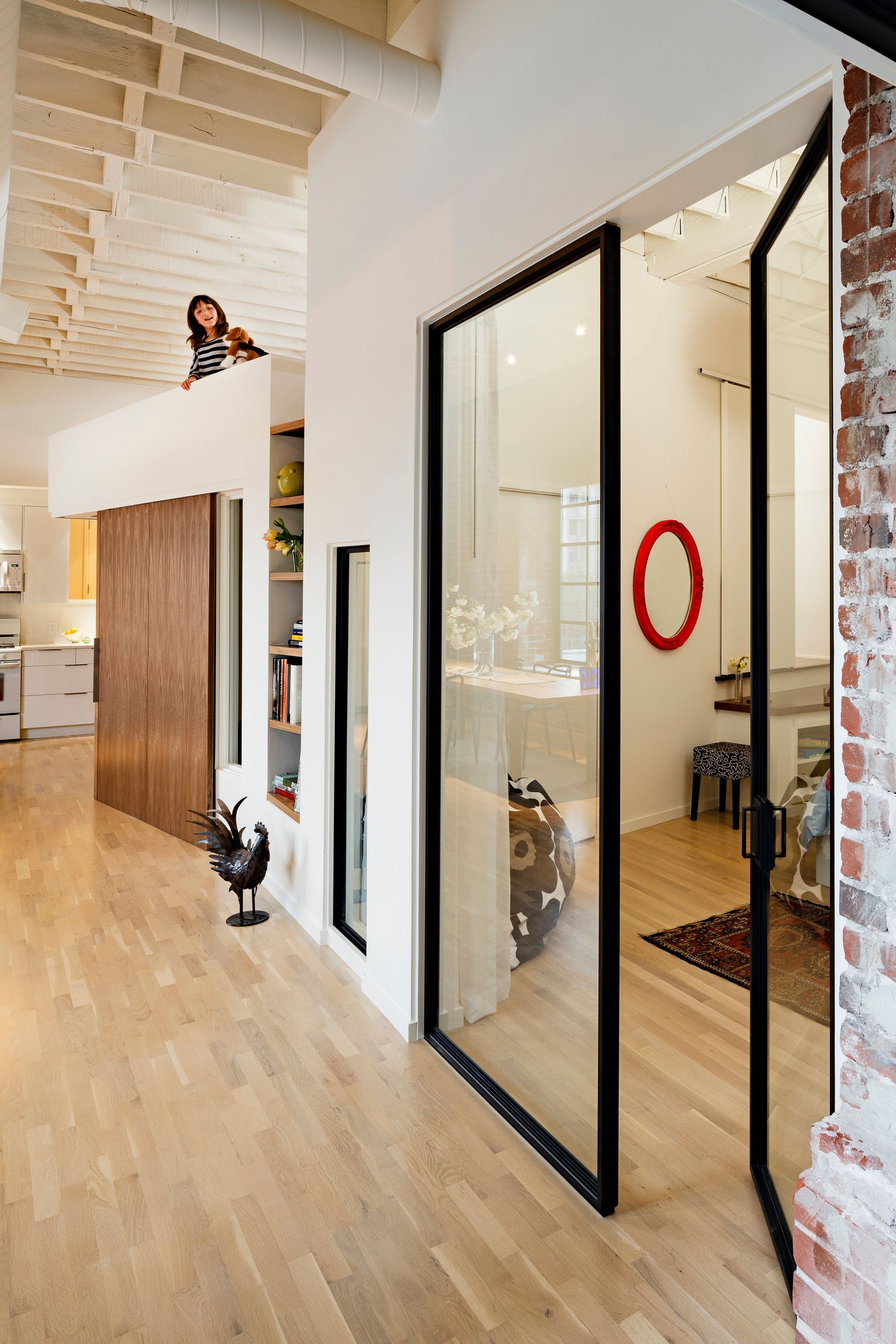 A hallway with sliding glass doors and a red circle on the wall