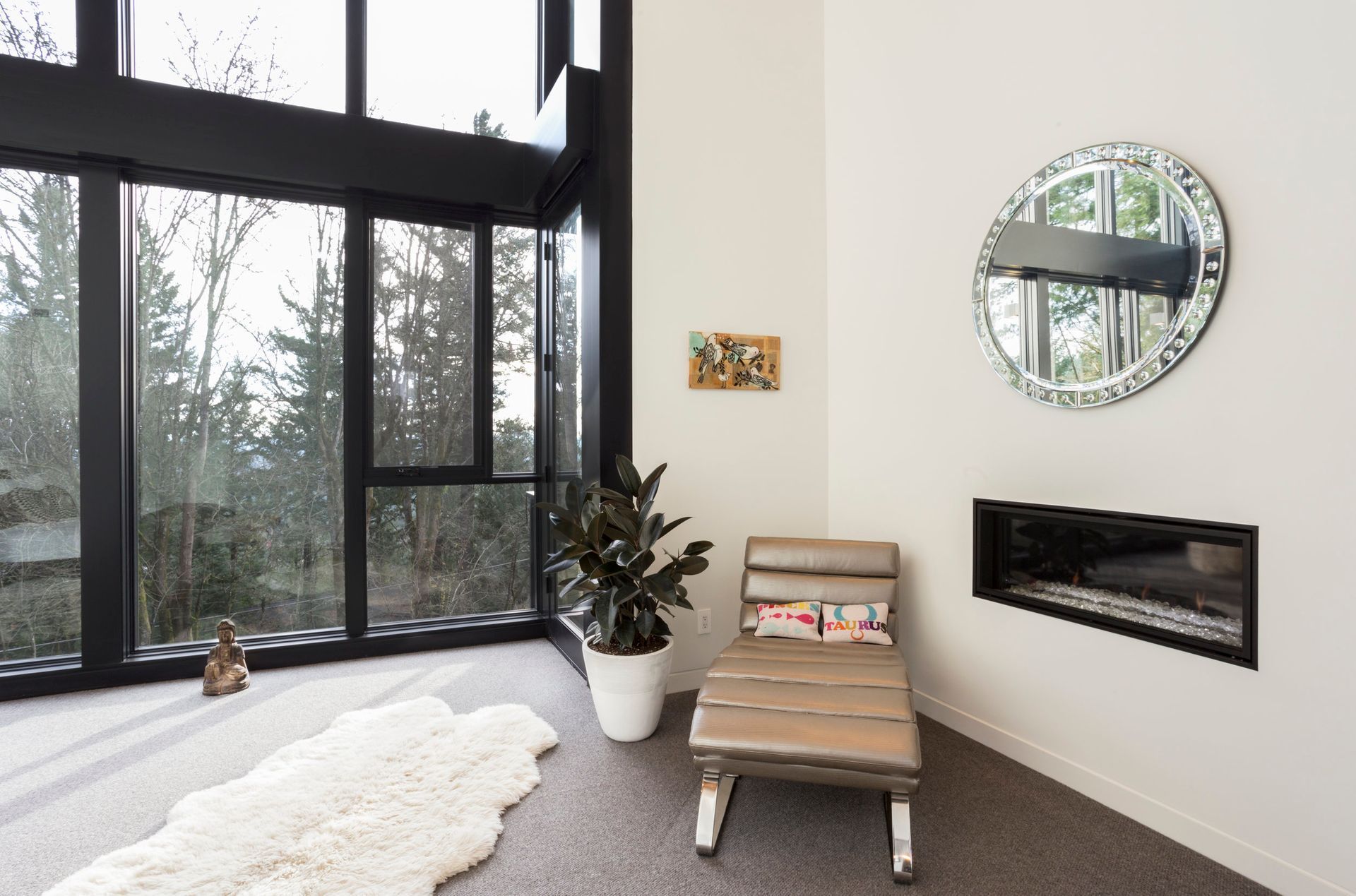 A living room with a chaise lounge and a fireplace.