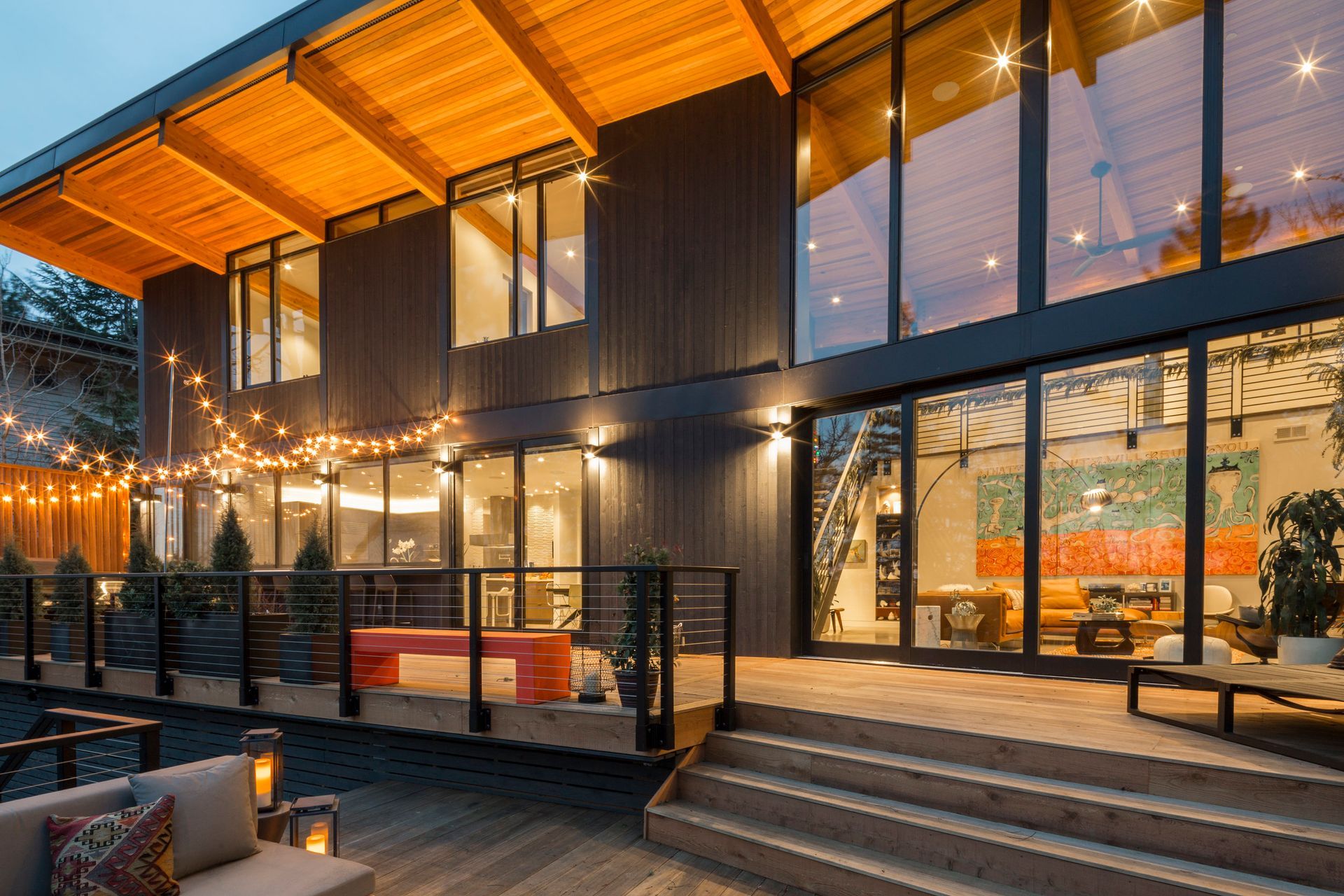 A large house with a lot of windows and a large deck.