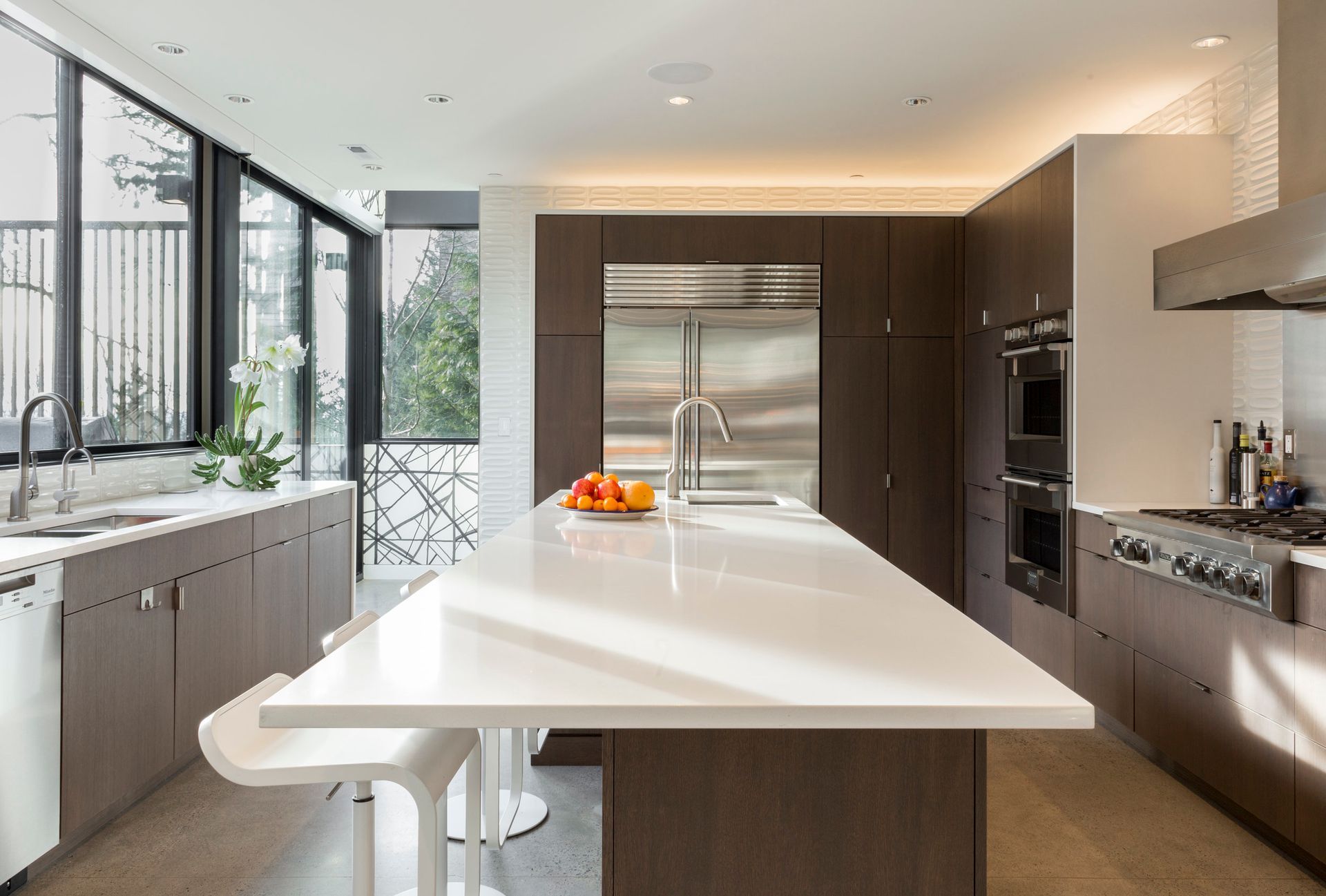 A kitchen with a large island and stainless steel appliances