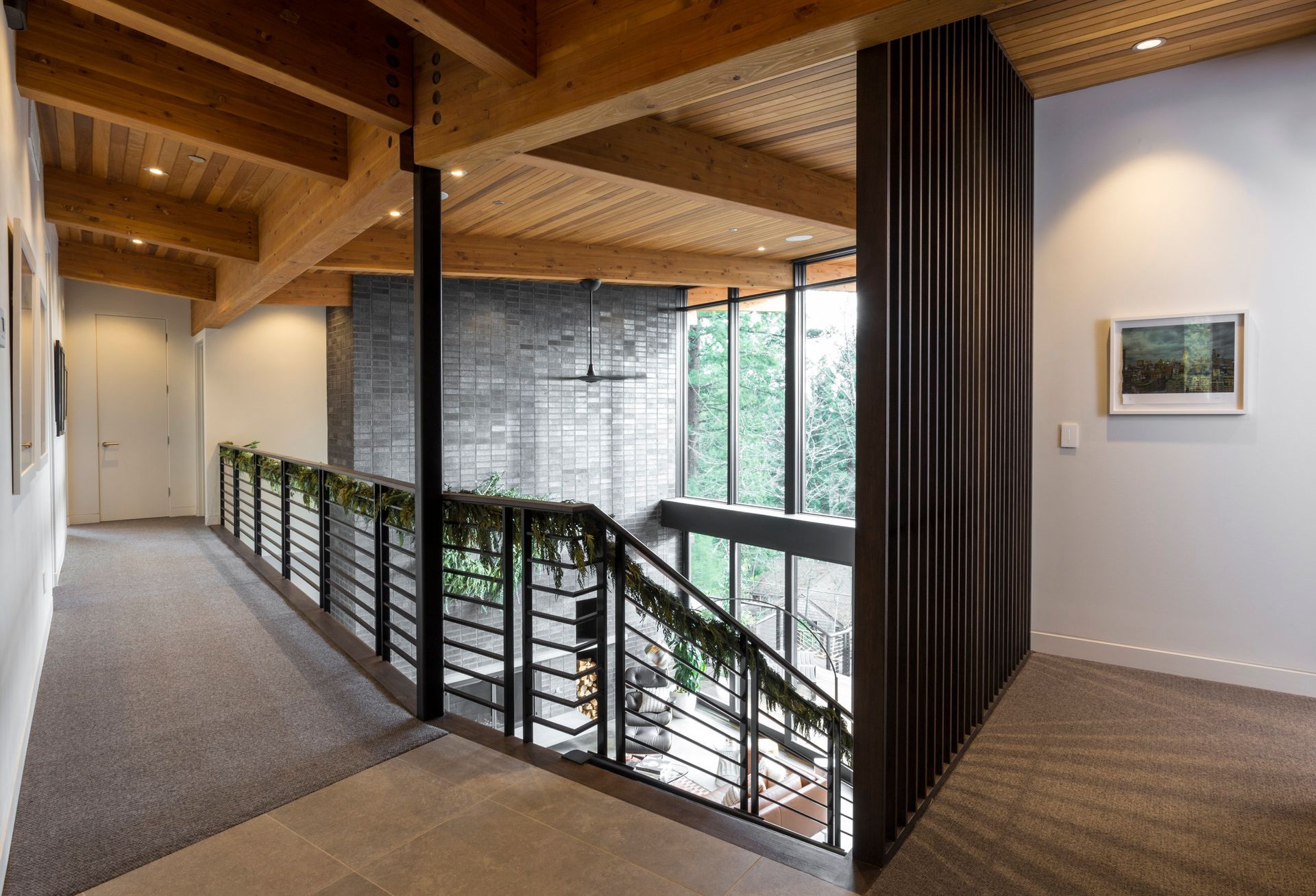 A hallway with a staircase and a picture on the wall.
