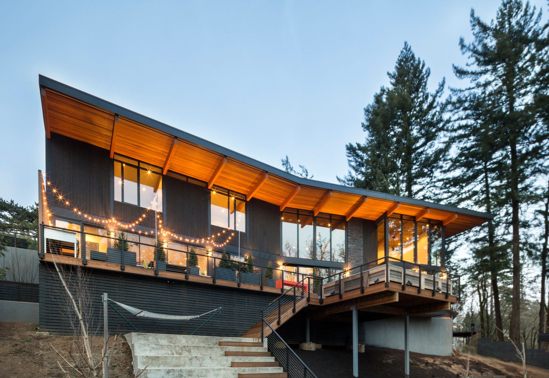 A house with a wooden deck and stairs leading up to it