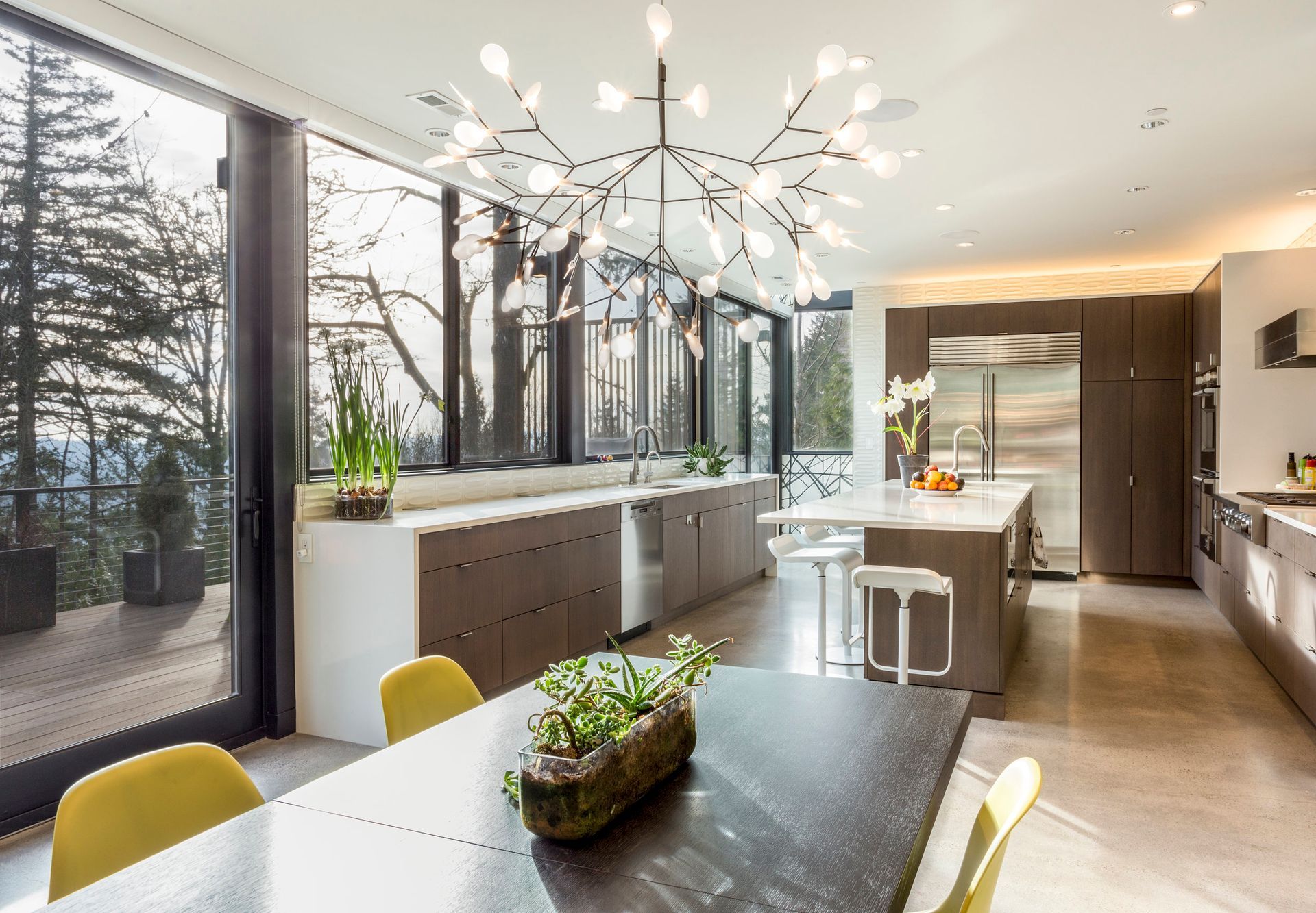 A kitchen with a table and chairs and a chandelier hanging from the ceiling.
