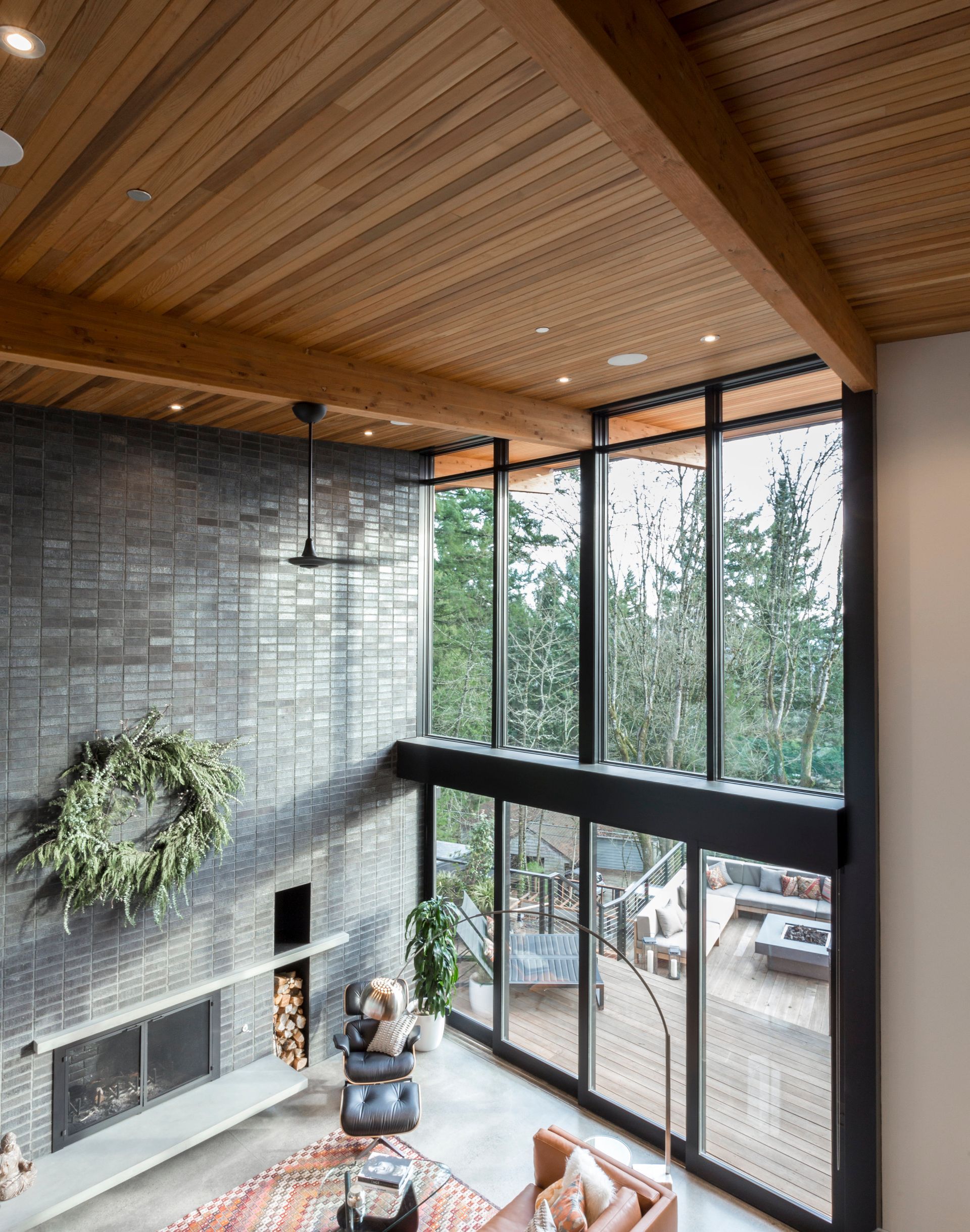 A living room with a lot of windows and a fireplace.