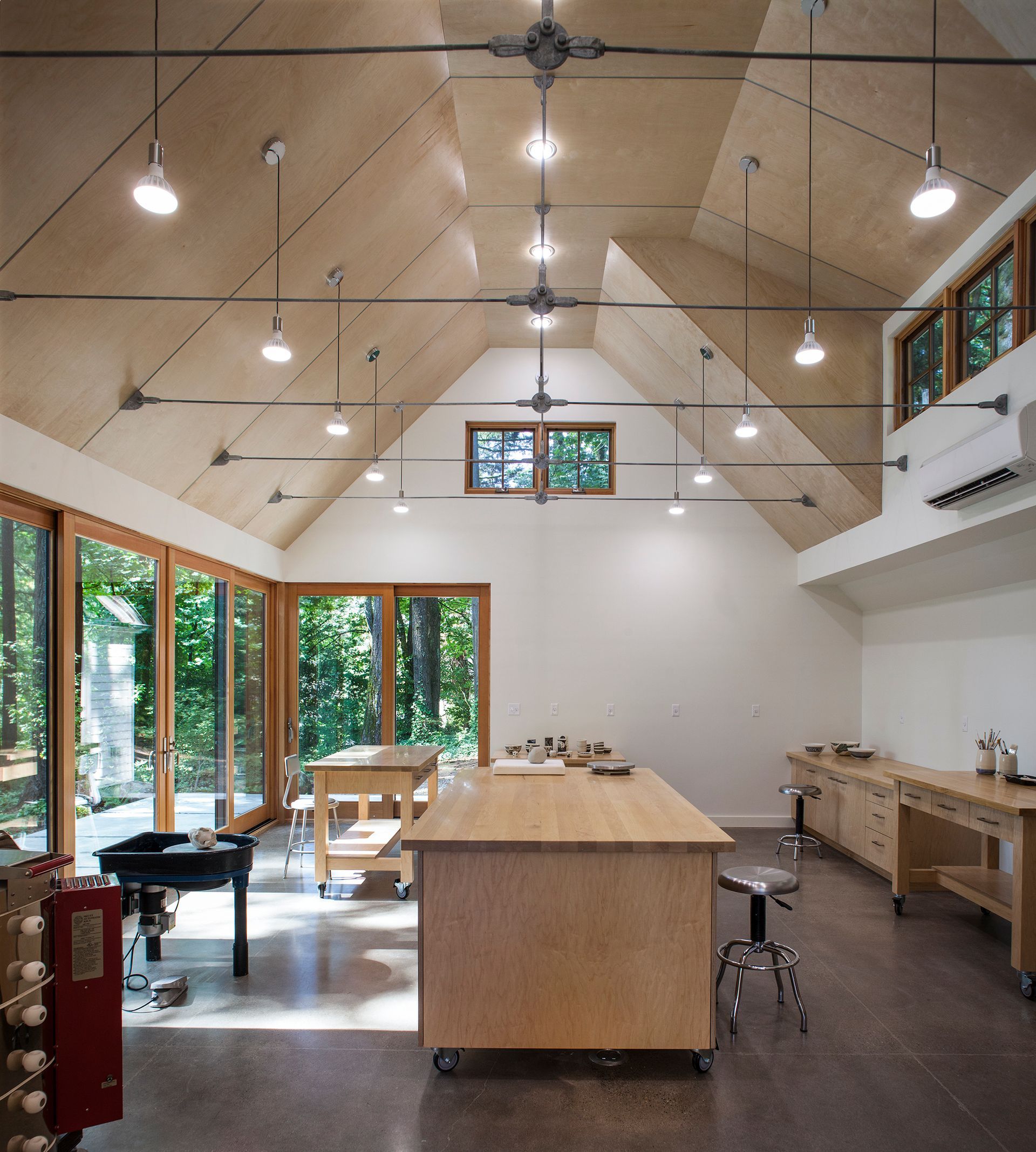 A large room with a wooden table in the middle