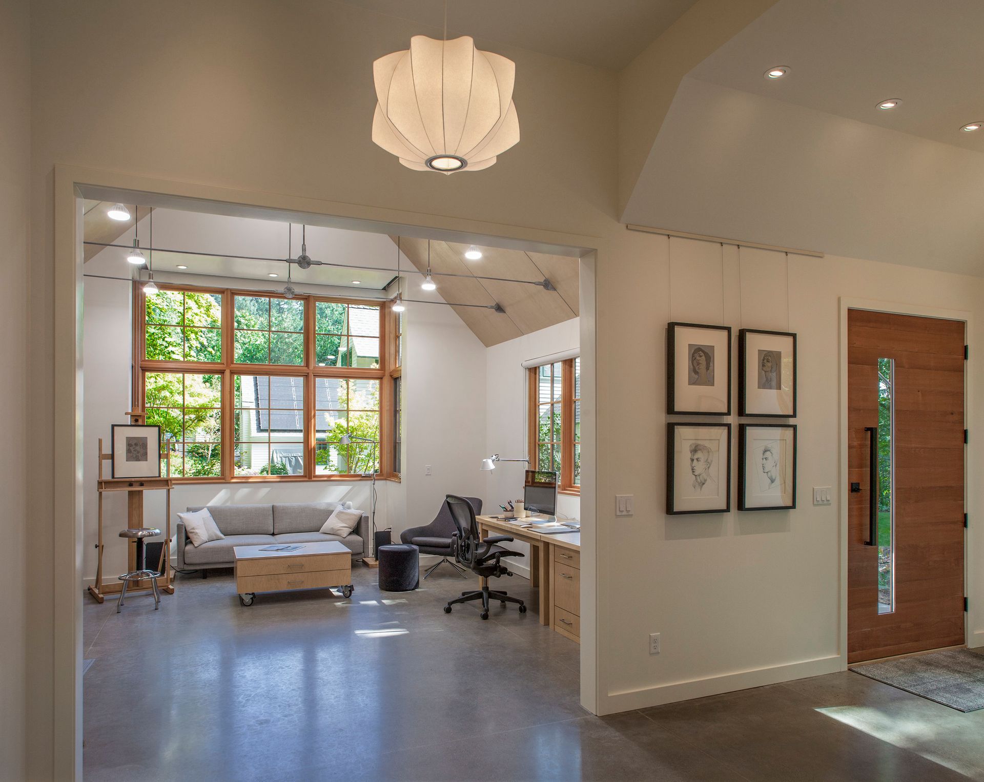 A living room with a couch and a desk