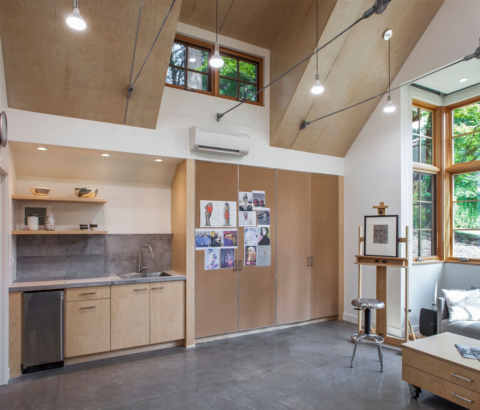 A room with a lot of windows and cabinets