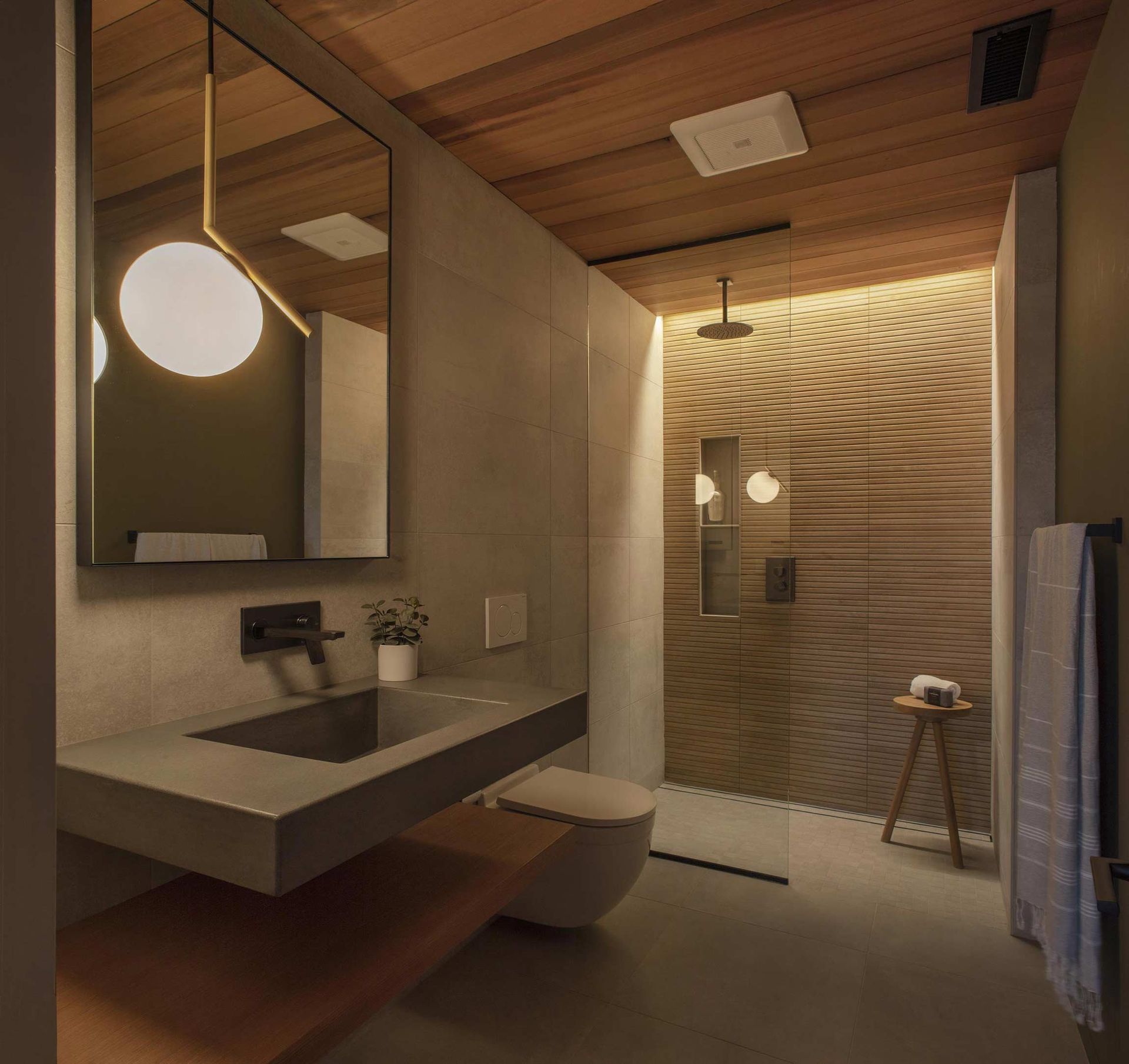 A bathroom with a sink a toilet and a shower.