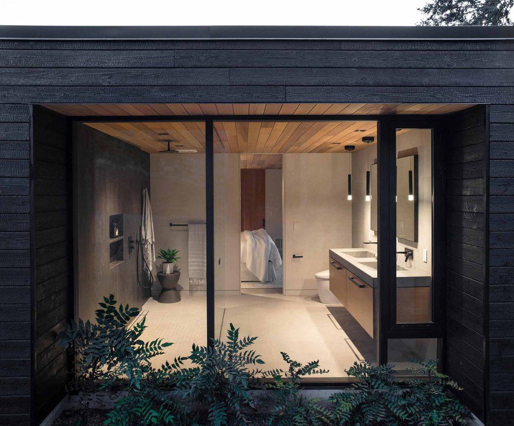 A bathroom with two sinks and a sliding glass door.