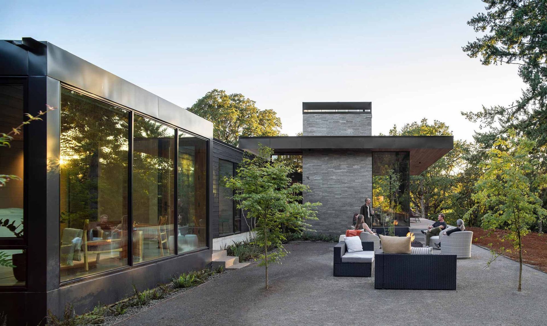 A modern house with a lot of windows and a patio area.