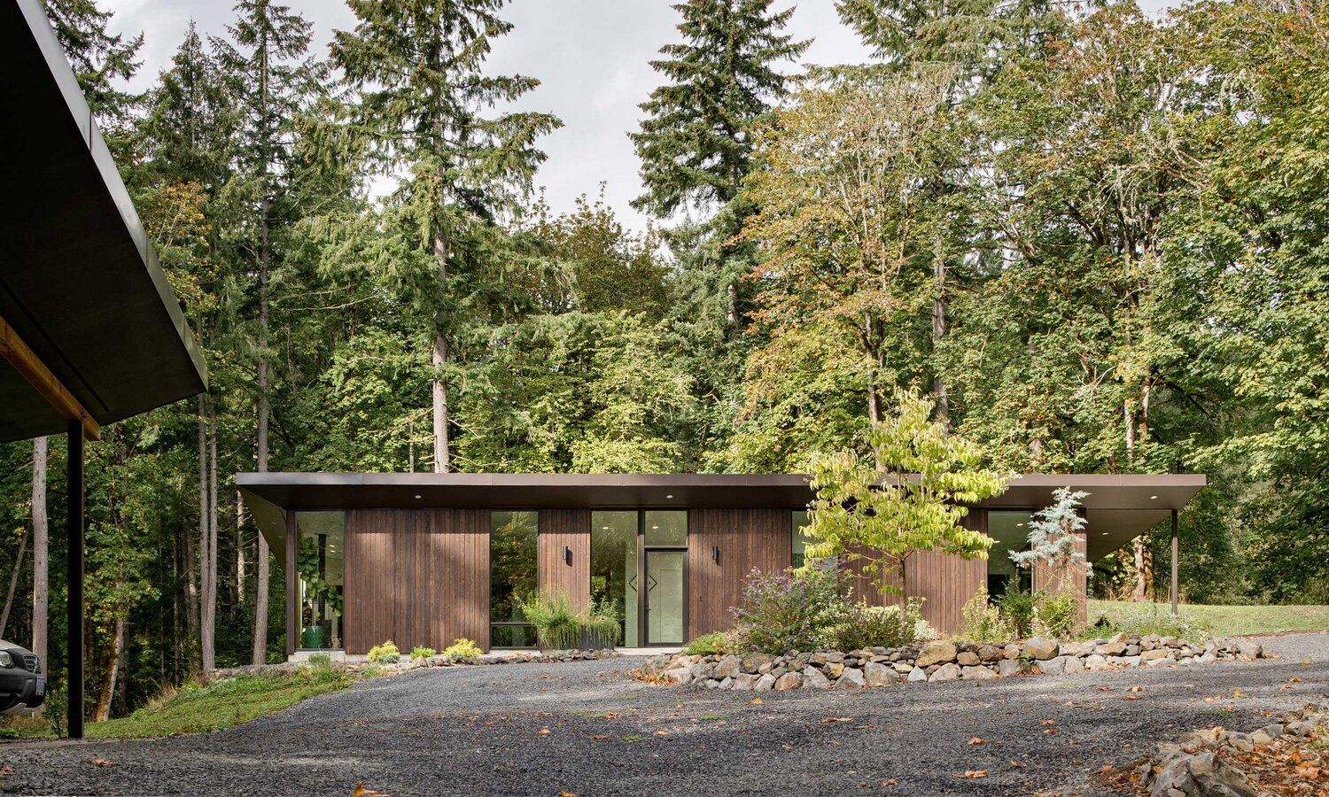 A small house is sitting in the middle of a forest.