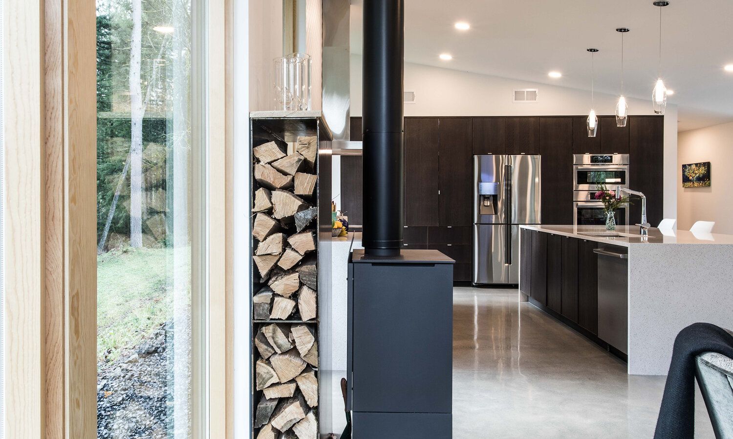 There is a wood stove in the middle of the kitchen.