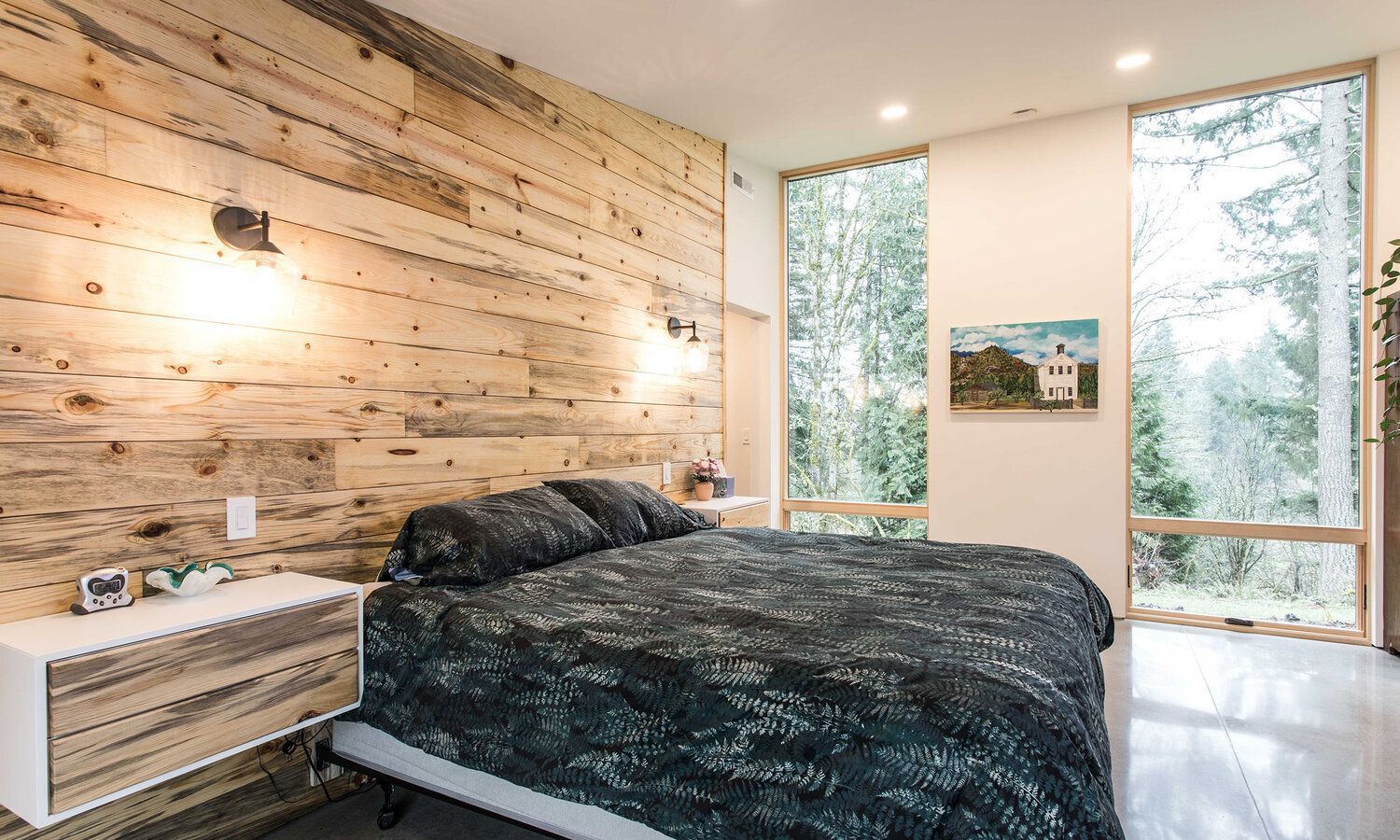 A bedroom with a large bed and a wooden wall.