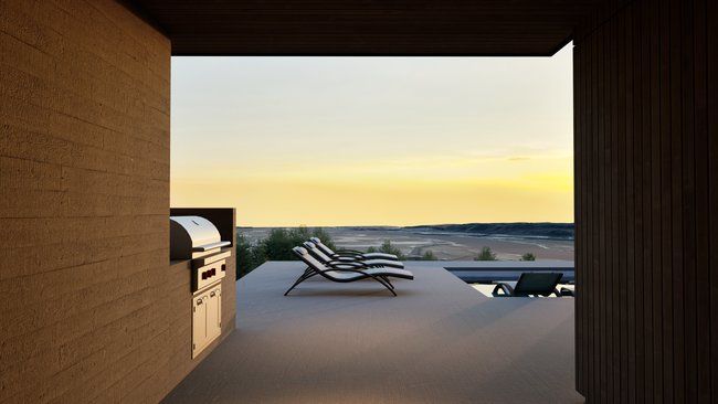 A view of a patio with chairs and a grill