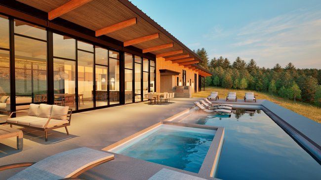 A large house with a large swimming pool in front of it.