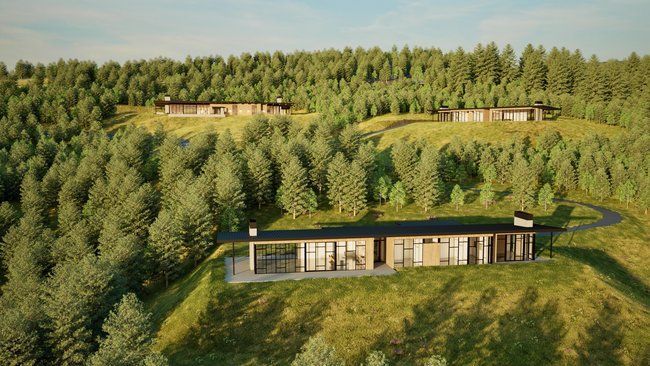 An aerial view of a house on top of a hill surrounded by trees.