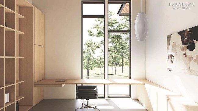 A room with a desk and chair and a large window.