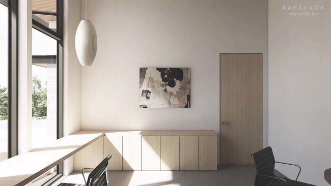 A room with a painting on the wall and a chair.