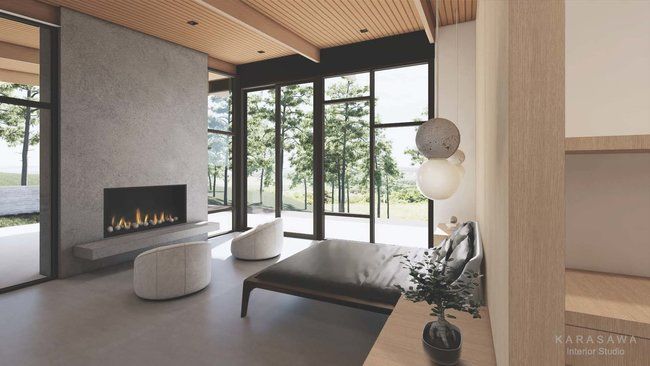 A living room with a fireplace and a lot of windows