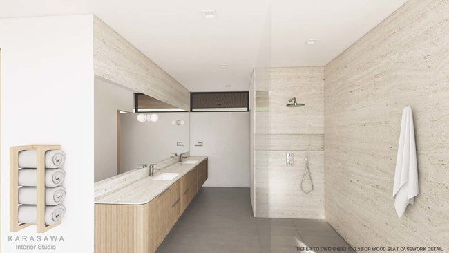 A bathroom with two sinks and a walk in shower