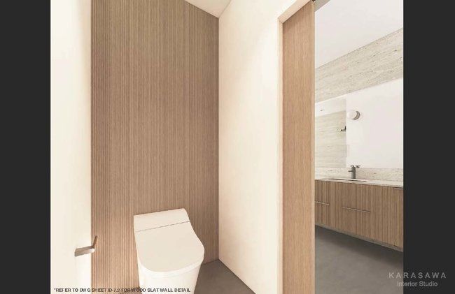 A bathroom with a toilet and a wooden wall.